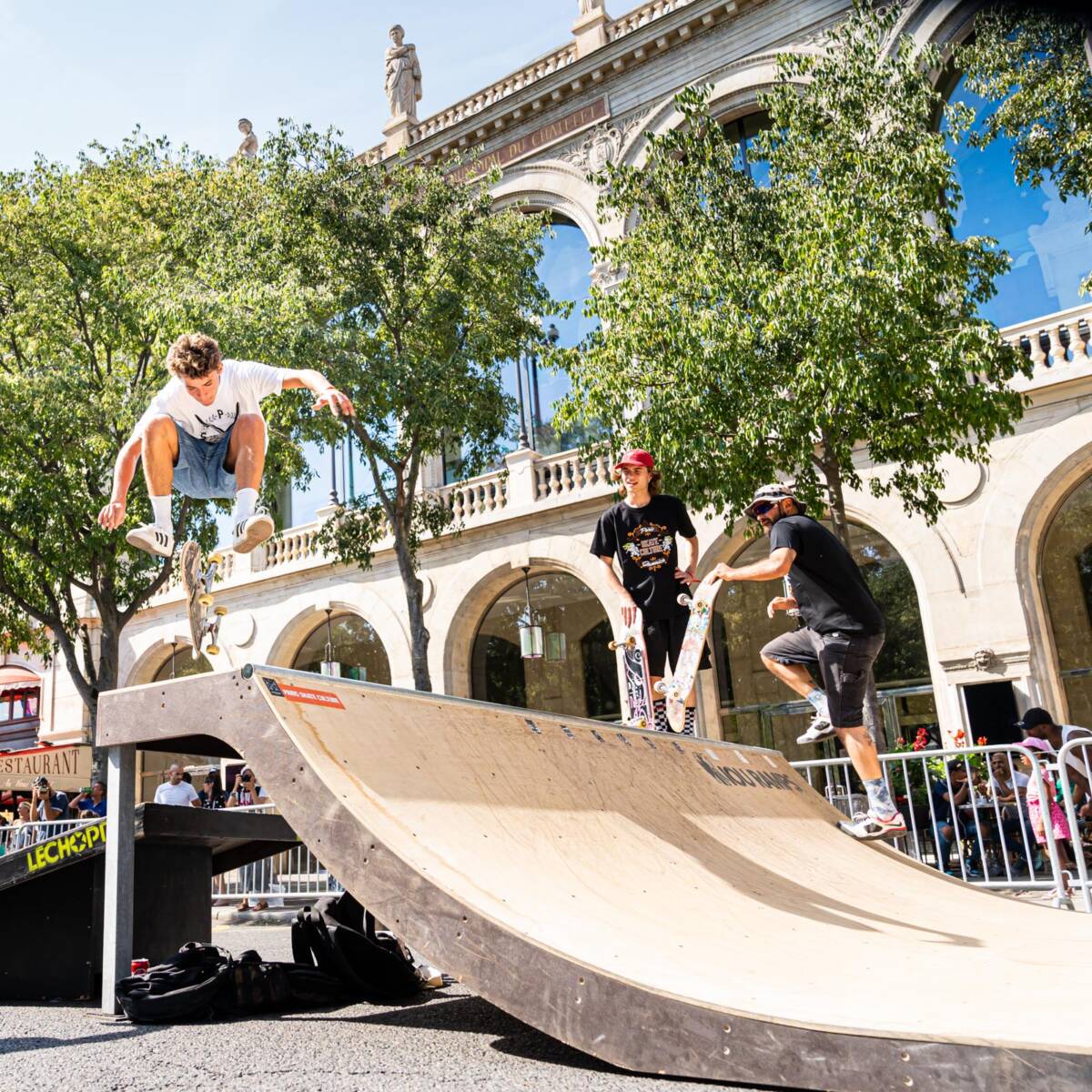 Trois jeunes homme faisant du skate sur une rampe